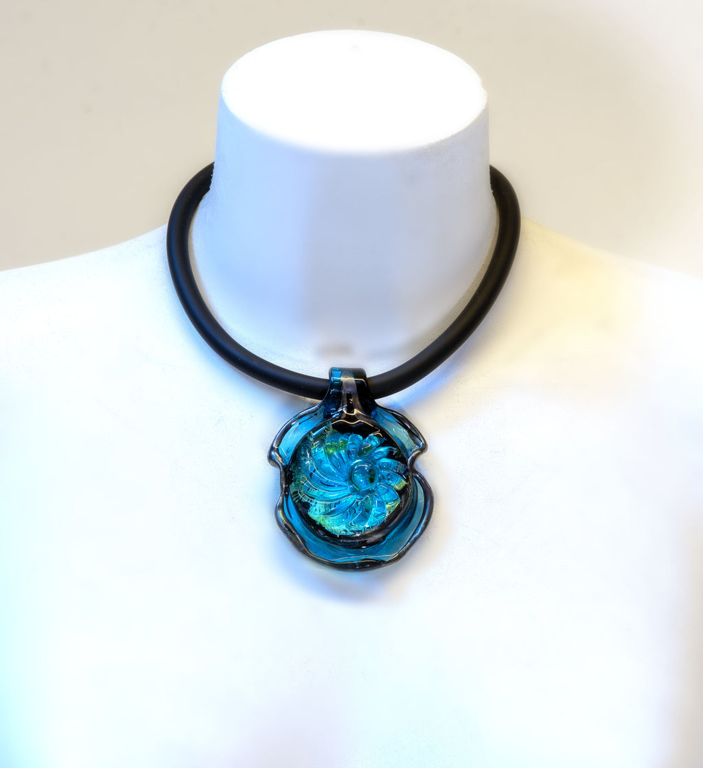 Handmade Murano glass pendant necklace with aquamarine center, silver foil and iridescent black rim, on black rubber cord