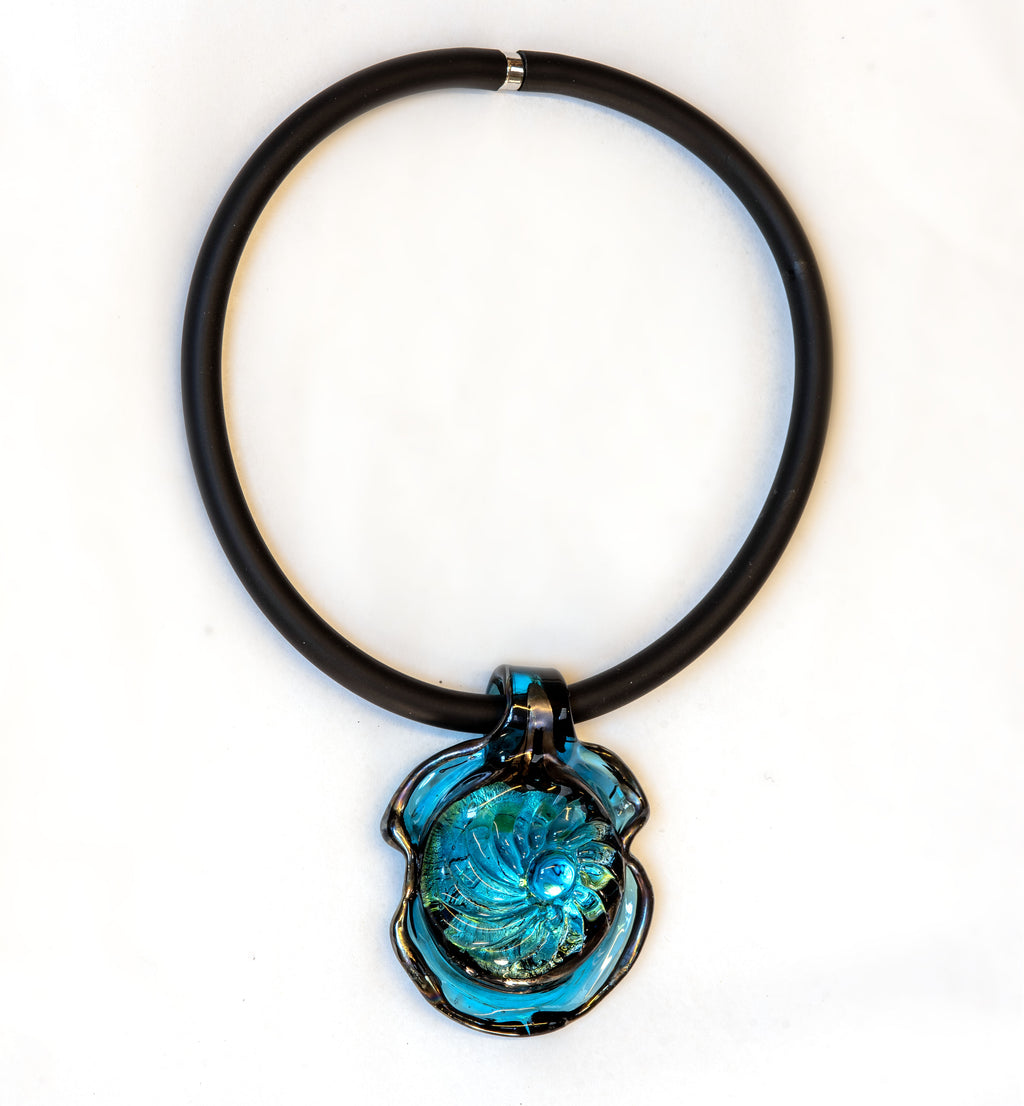 Handmade Murano glass pendant necklace with aquamarine center, silver foil and iridescent black rim, on black rubber cord